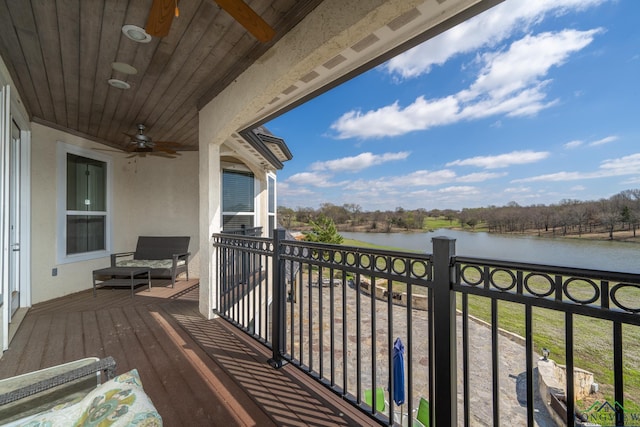 balcony featuring ceiling fan and a water view