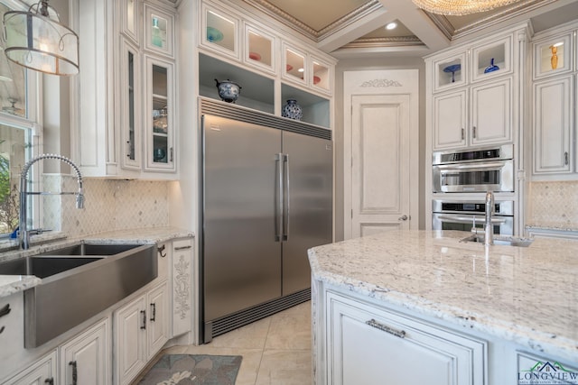 kitchen featuring sink, coffered ceiling, beamed ceiling, pendant lighting, and appliances with stainless steel finishes