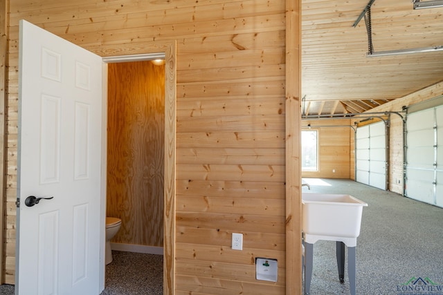 interior space featuring wood walls and toilet