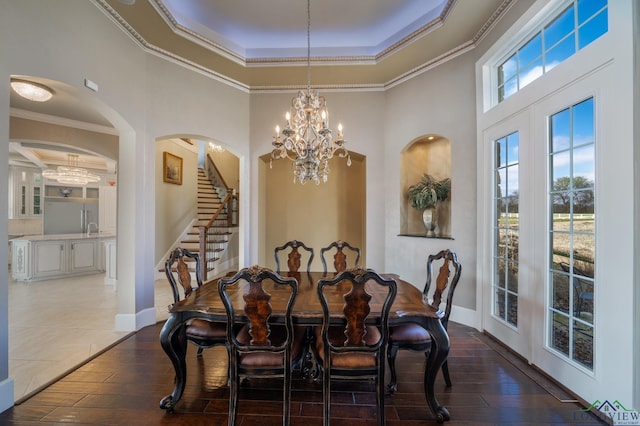 dining room with crown molding, plenty of natural light, dark wood-type flooring, and french doors