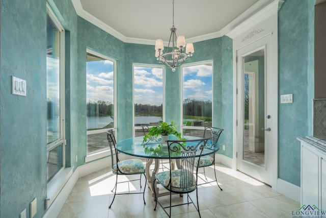 sunroom / solarium with a healthy amount of sunlight, a water view, and a notable chandelier