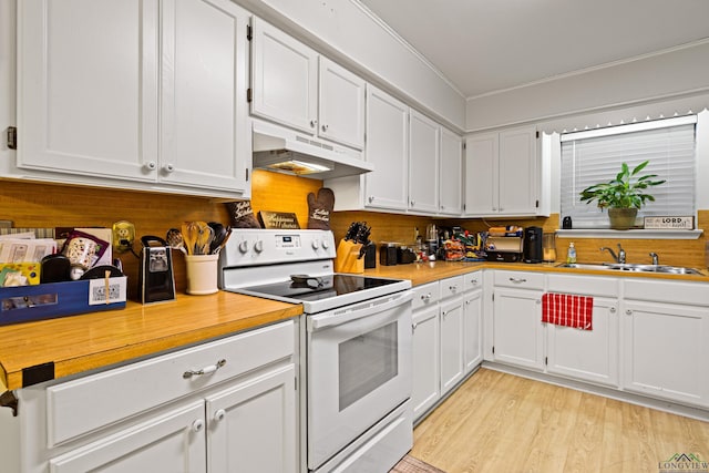 kitchen with white electric range oven, sink, and white cabinets