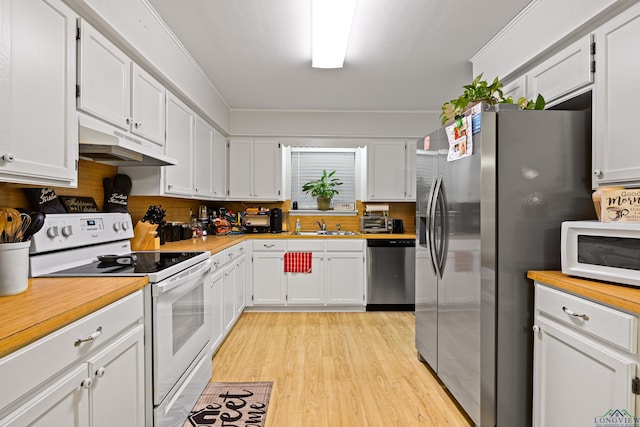 kitchen with white cabinetry, sink, stainless steel appliances, and light hardwood / wood-style floors