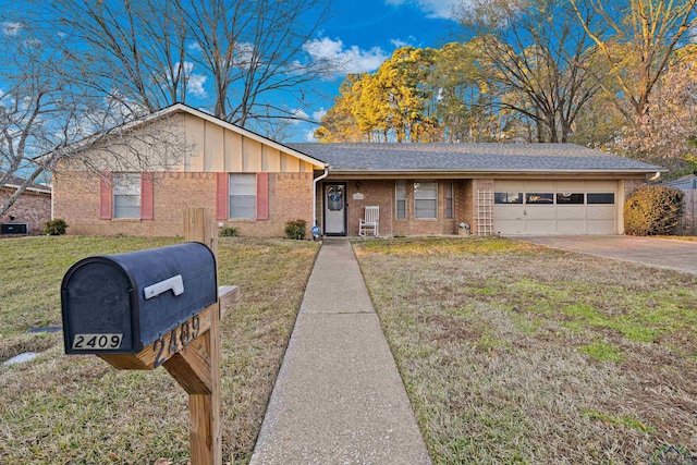 ranch-style house featuring a garage and a front lawn