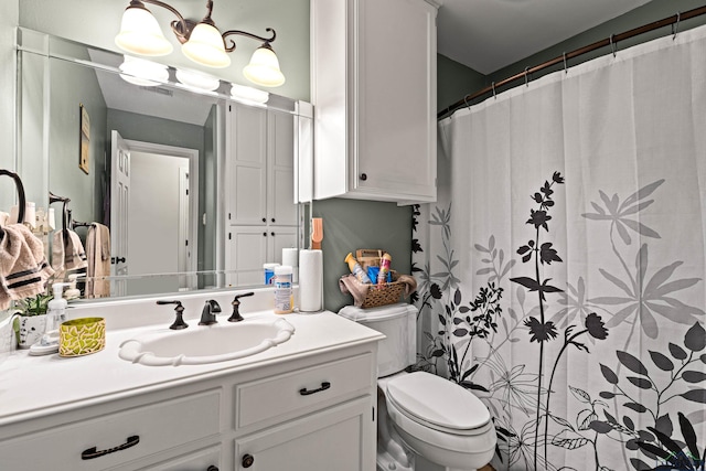 bathroom with a shower with curtain, vanity, and toilet