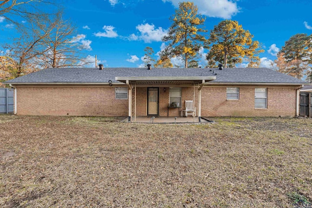 rear view of property with a yard and a patio