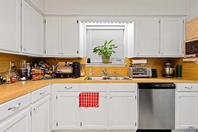 kitchen with white cabinetry, sink, stainless steel dishwasher, and backsplash