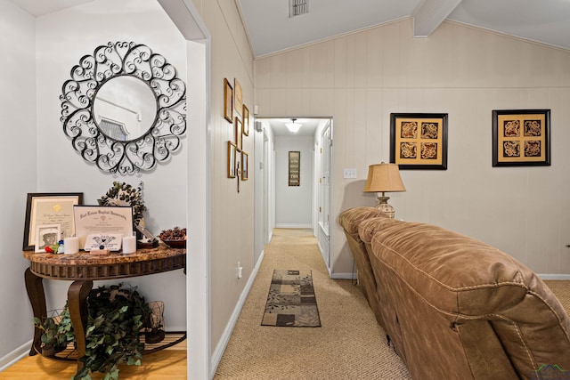 hallway featuring light colored carpet and lofted ceiling with beams