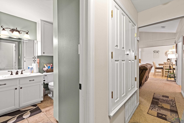 bathroom with tile patterned flooring, vanity, and toilet