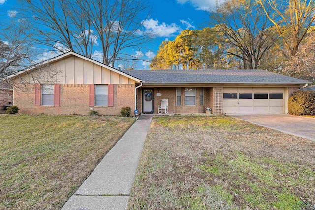 ranch-style house featuring a garage and a front lawn