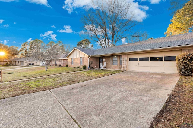 single story home featuring a garage and a front lawn