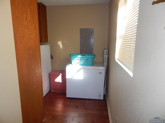 washroom with cabinets, independent washer and dryer, dark hardwood / wood-style flooring, and electric panel