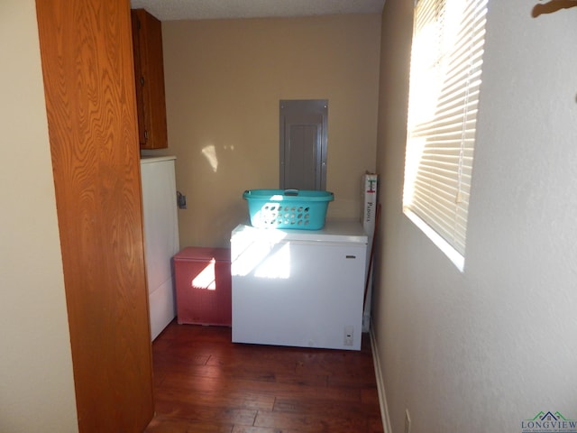 3073 E Lake Dr, Gladewater, TX 75647 - washroom with independent washer and dryer, plenty of natural light, cabinet space, and wood finished floors