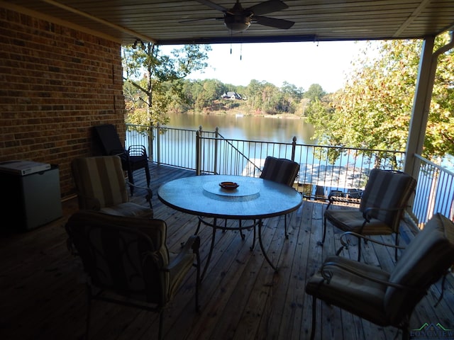 3073 E Lake Dr, Gladewater, TX 75647 - wooden terrace with a water view, a ceiling fan, and outdoor dining space