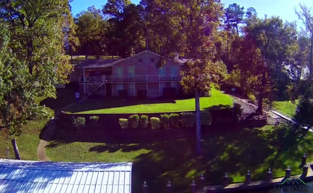 3073 E Lake Dr, Gladewater, TX 75647 - exterior space with a yard and a metal roof
