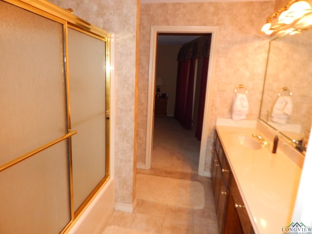 bathroom featuring vanity and bath / shower combo with glass door