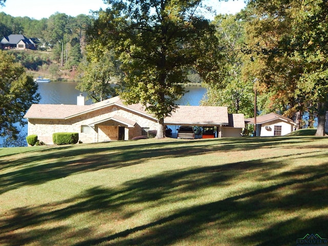 exterior space featuring a front lawn and a water view