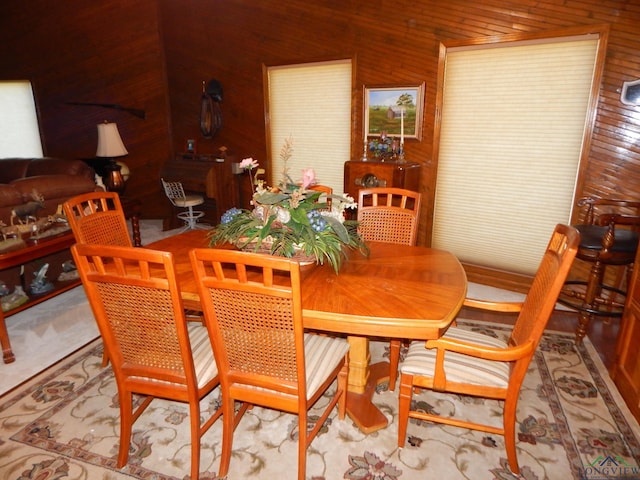 dining area featuring wooden walls