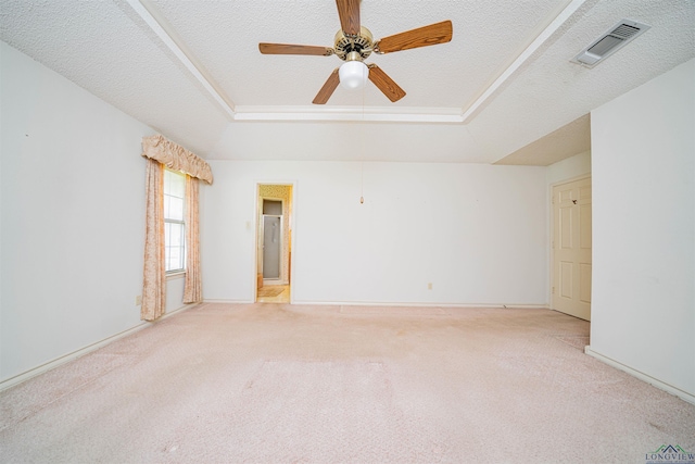 3714 Bill Owens Pkwy, Longview, TX 75605 - spare room with a tray ceiling, light colored carpet, a ceiling fan, a textured ceiling, and baseboards
