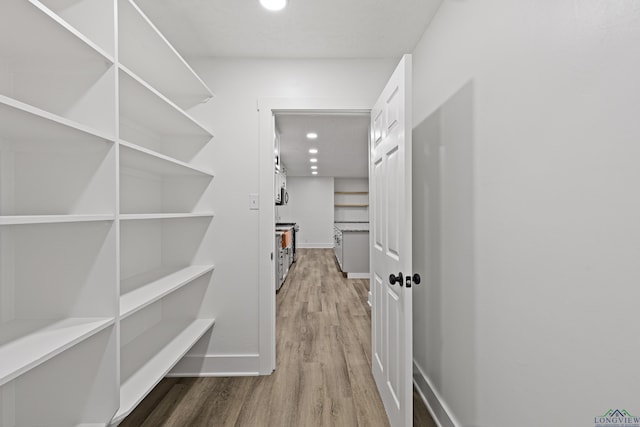 spacious closet featuring hardwood / wood-style floors