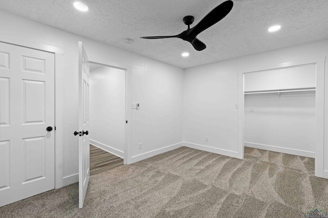 unfurnished bedroom featuring ceiling fan, carpet floors, and a textured ceiling