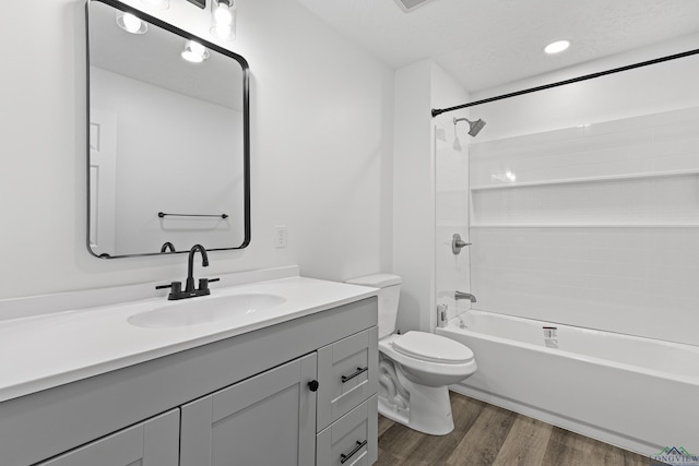 full bathroom with toilet, vanity, bathtub / shower combination, and hardwood / wood-style flooring