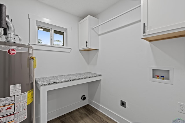 clothes washing area with cabinets, dark wood-type flooring, gas water heater, washer hookup, and hookup for an electric dryer