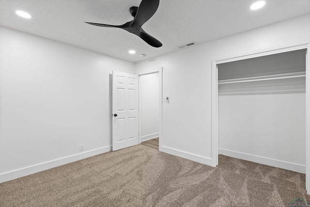 unfurnished bedroom with carpet, ceiling fan, and a closet