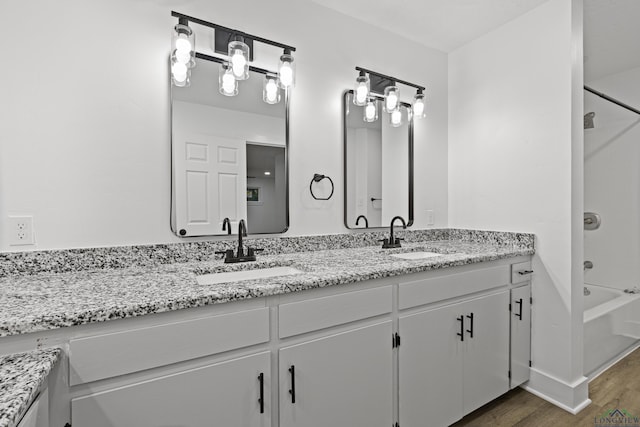 bathroom with shower / tub combination, vanity, and wood-type flooring