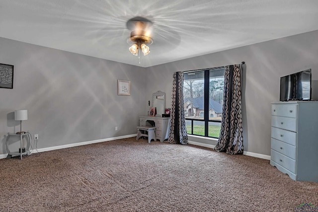 interior space with carpet floors, baseboards, and a ceiling fan