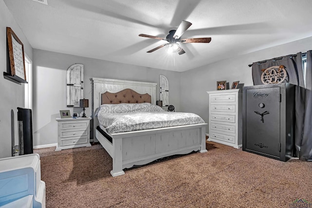 carpeted bedroom with ceiling fan, a textured ceiling, and baseboards