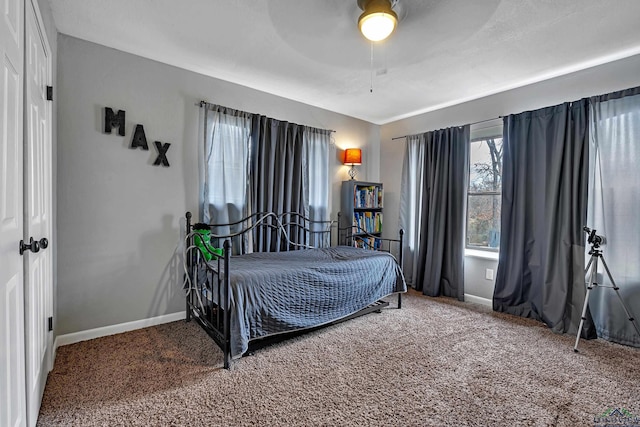 bedroom with carpet flooring, a ceiling fan, and baseboards