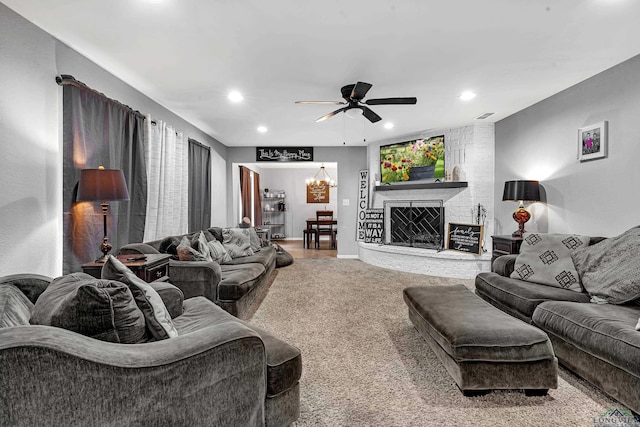 carpeted living area with a fireplace, visible vents, a ceiling fan, and recessed lighting