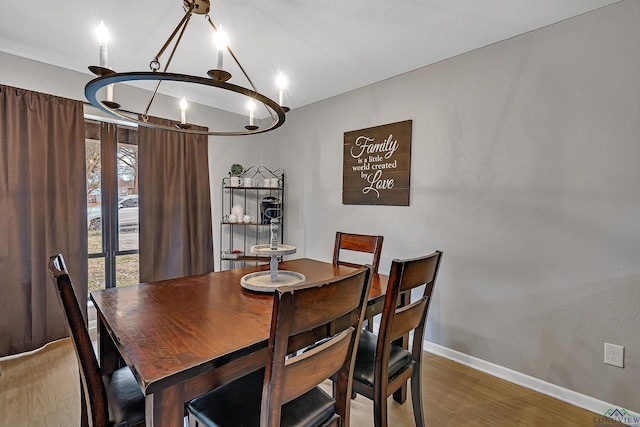 dining room with baseboards and wood finished floors