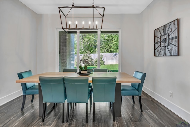 dining space with a notable chandelier, baseboards, and dark wood-style flooring