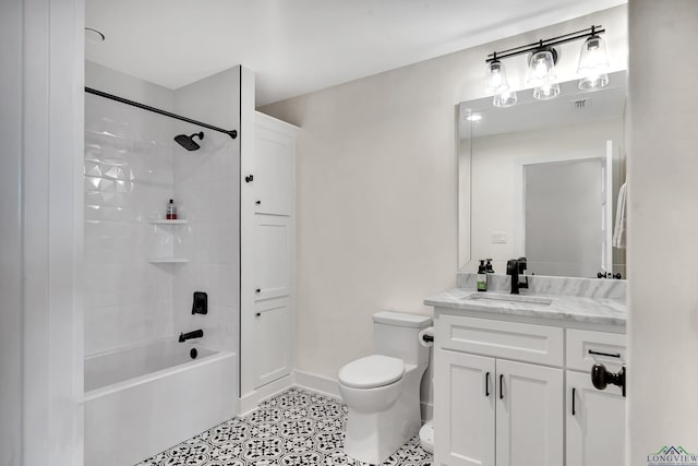bathroom featuring tile patterned floors, toilet, vanity, baseboards, and shower / bathing tub combination