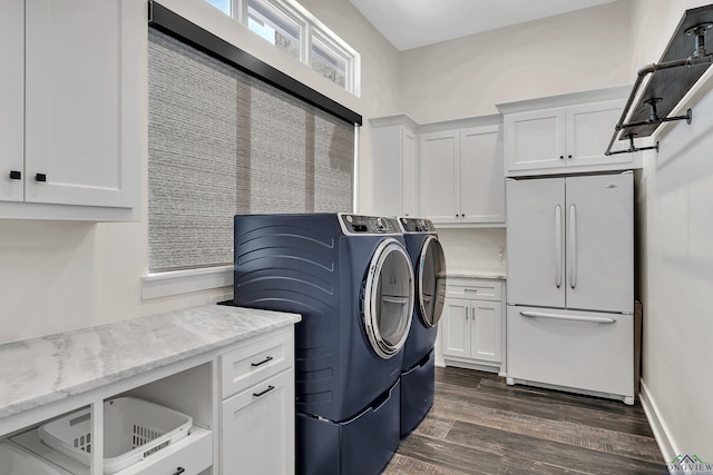 laundry area with cabinet space, dark wood finished floors, and washer and clothes dryer