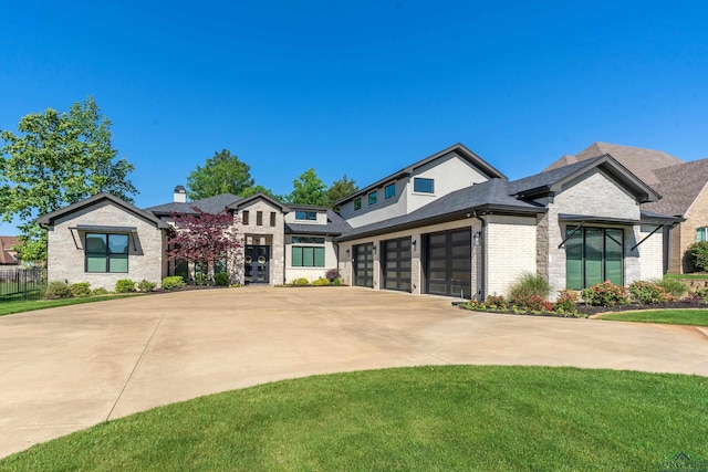 view of front of property with roof with shingles, an attached garage, driveway, stone siding, and brick siding