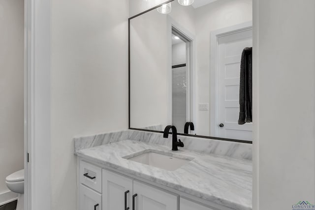 bathroom with vanity and toilet