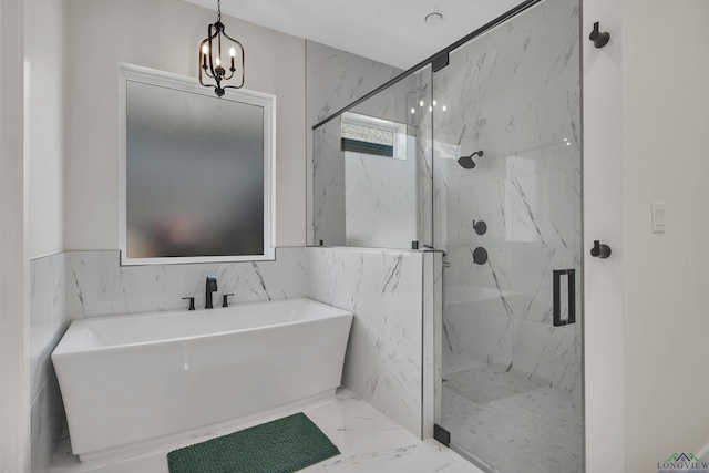 bathroom featuring a freestanding bath, marble finish floor, and a marble finish shower