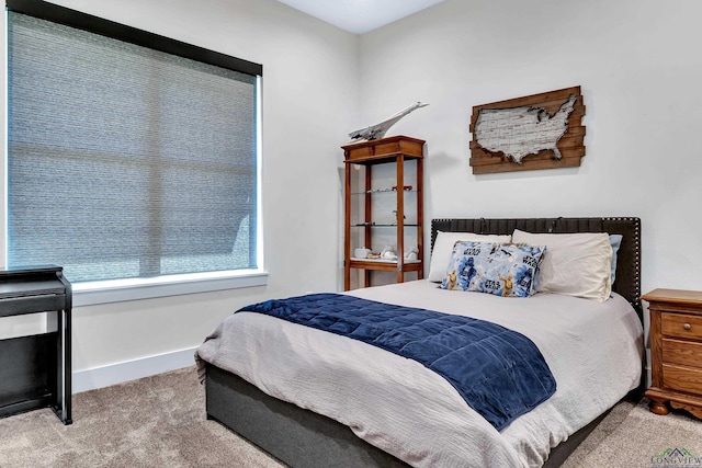 bedroom with carpet floors and baseboards