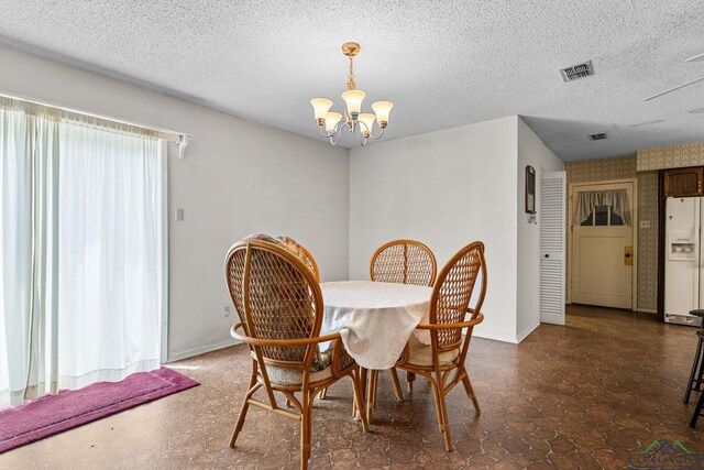 6940 Fm 778, Hawkins, TX 75765 - dining area with a chandelier, baseboards, and a textured ceiling