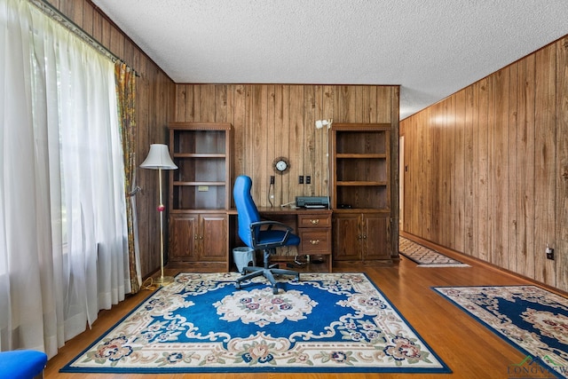 6940 Fm 778, Hawkins, TX 75765 - office with wood walls, a textured ceiling, and wood finished floors