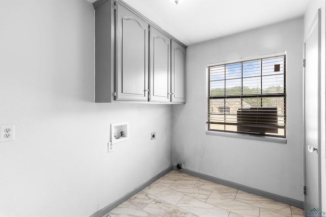 laundry room featuring electric dryer hookup, marble finish floor, washer hookup, cabinet space, and baseboards