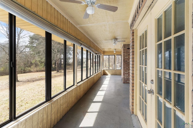 unfurnished sunroom featuring ceiling fan