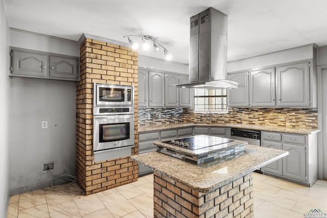 kitchen featuring a sink, stainless steel appliances, island range hood, and gray cabinets