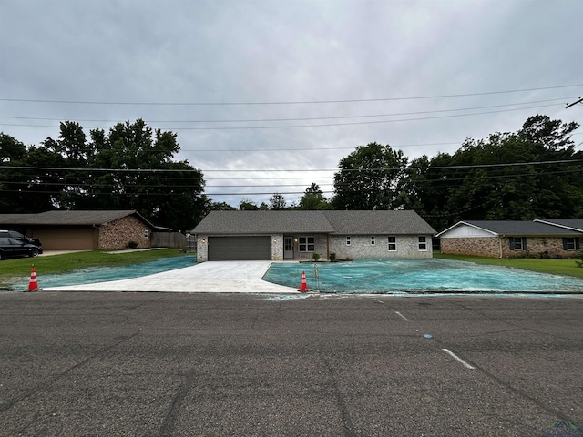 115 Alta St, Longview, TX 75604 - ranch-style house with an outdoor pool, concrete driveway, a front lawn, and an attached garage