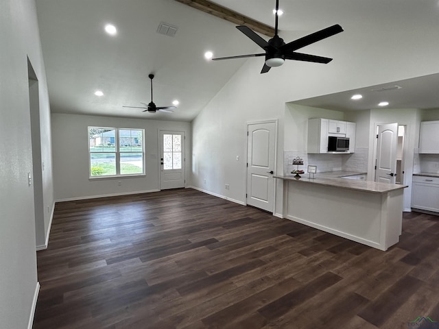 115 Alta St, Longview, TX 75604 - kitchen featuring stainless steel microwave, ceiling fan, high vaulted ceiling, white cabinets, and baseboards
