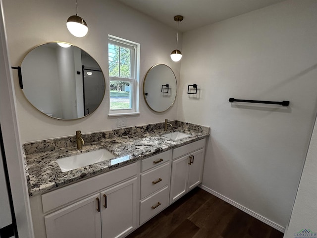 115 Alta St, Longview, TX 75604 - bathroom featuring wood finished floors, double vanity, and baseboards