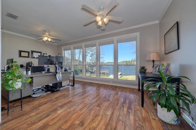 home office with wood-type flooring, ornamental molding, and a healthy amount of sunlight